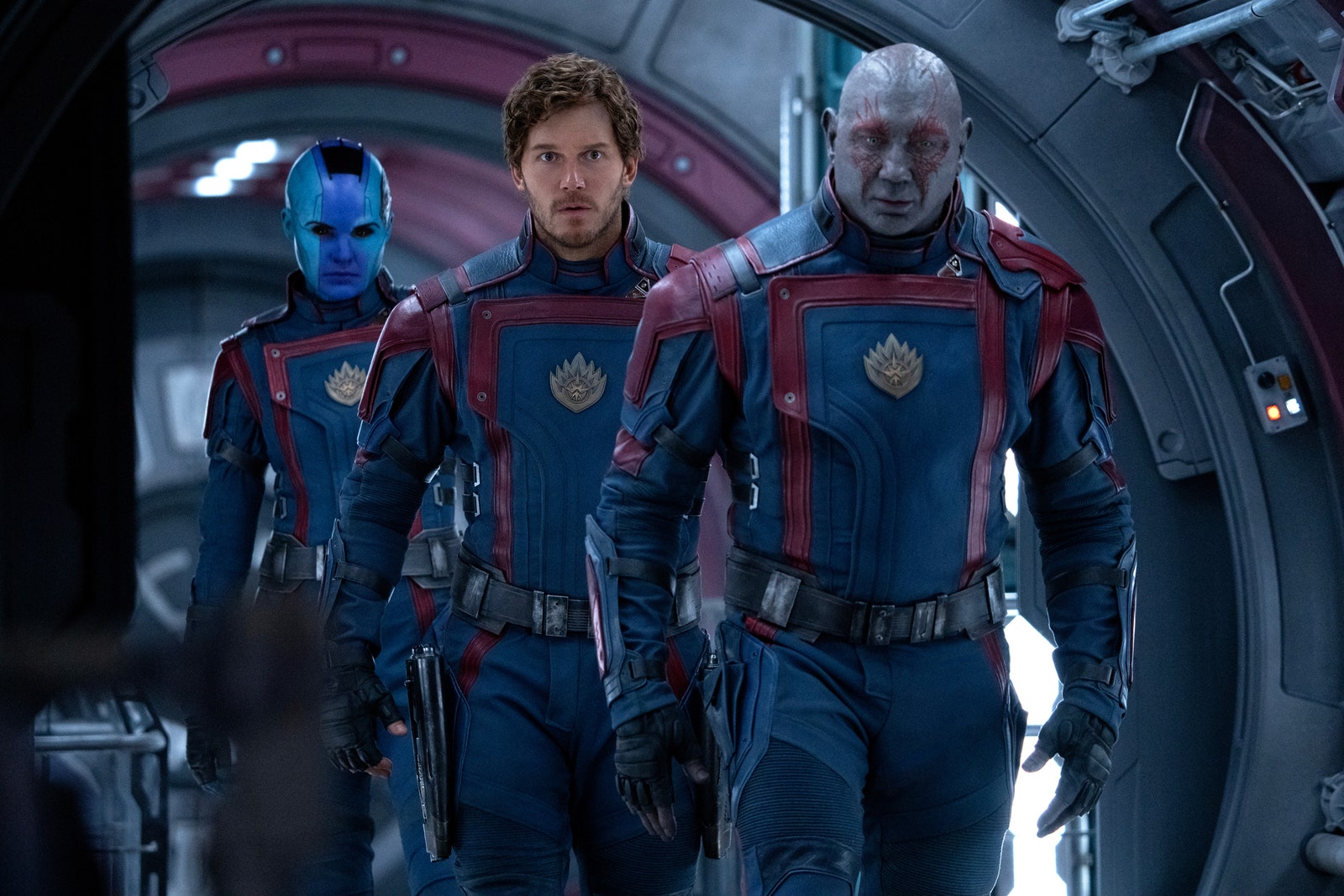 Still from the movie 'The Guardians of the Galaxy Vol. 3' featuring three characters walking down a spaceship tunnel